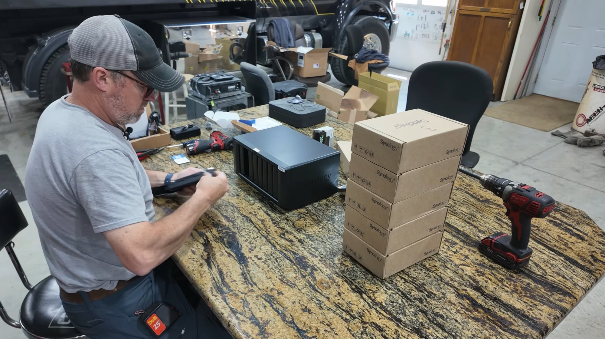 Patrick loading drives into the Synology DS1821+ on Neil's shop workbench